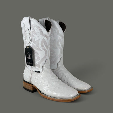 A pair of white ostrich cowboy boots with a square toe, genuine leather shaft, and a heel height of 1 1/2 inches. The boots are displayed against a gray background.